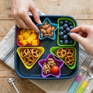 Using vibrant silicone cupcake liners as versatile bento box dividers to separate small portions of nuts and berries.