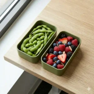 Colorful silicone bento dividers being used as effective lunch box accessories for adults to separate snacks and sides inside a sleek meal container.